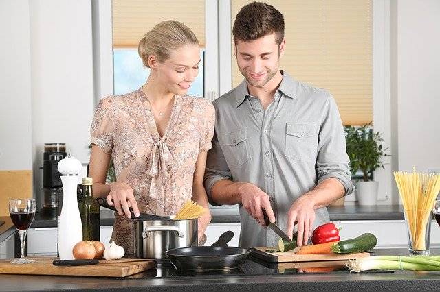 A woman and a man cooking food