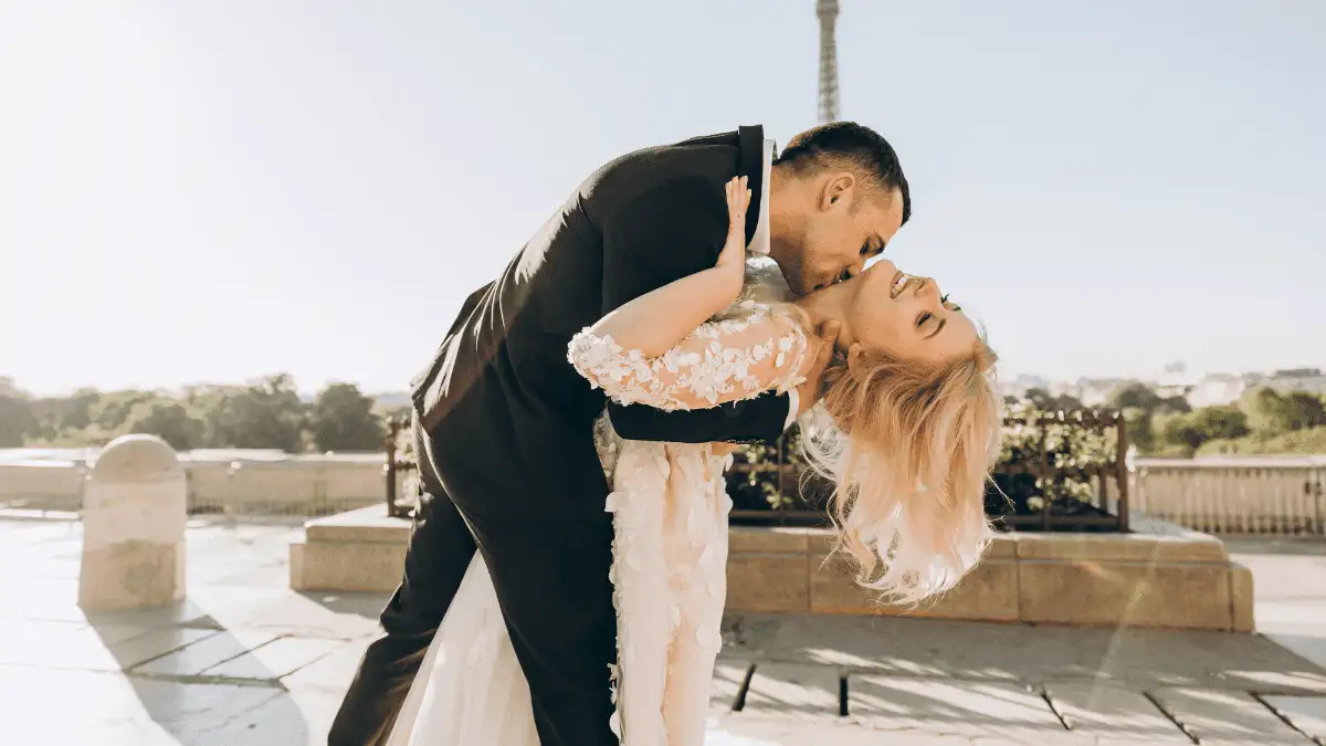 A guy kissing a girl on her neck