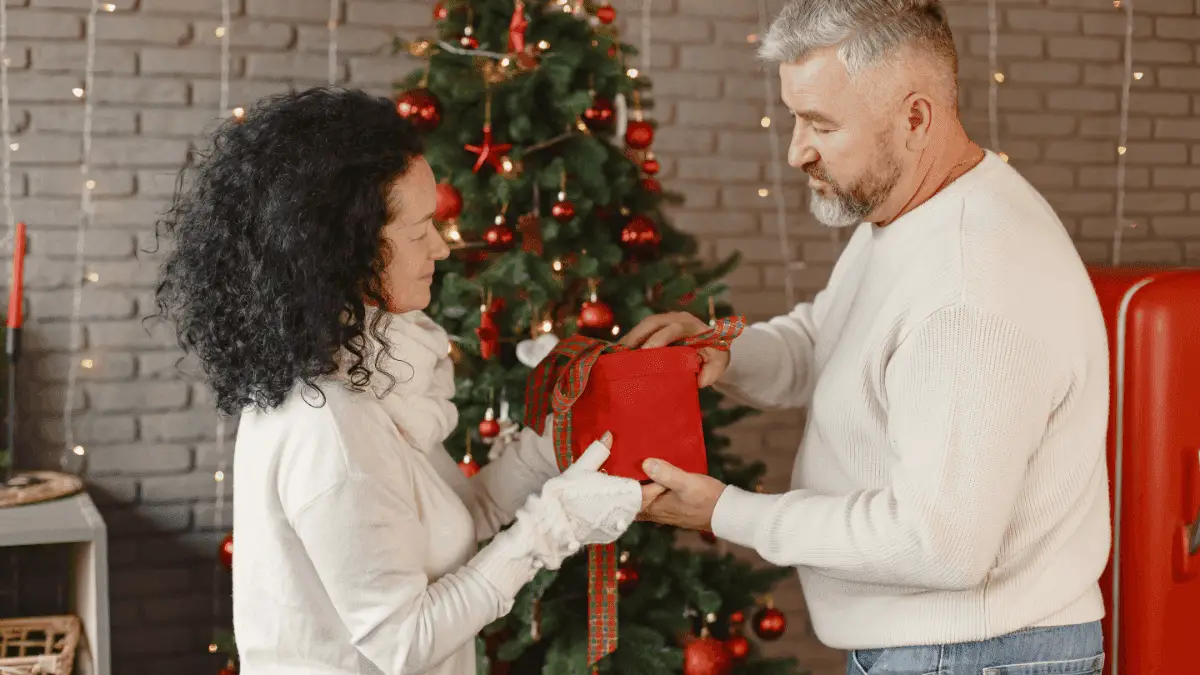 A woman receiving a gift from her partner