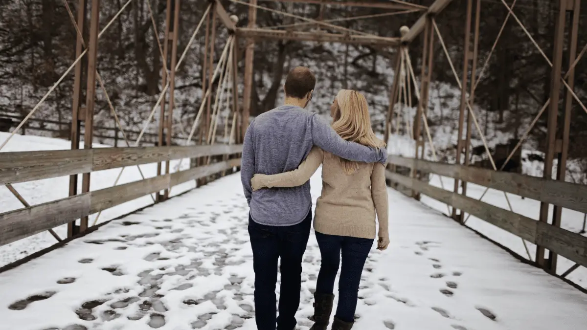 Couple walking on a snow ground