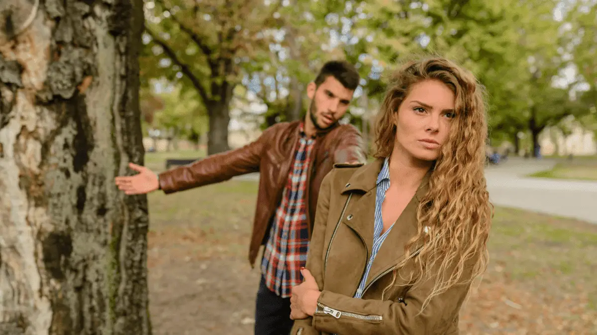 Woman and Man Wearing Brown Jackets Standing Near Tree