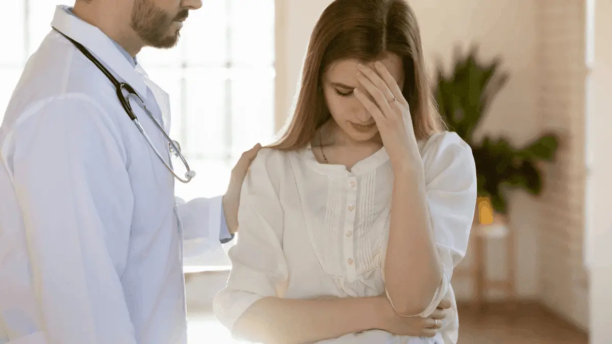 Attentive Compassionate Young Male Doctor Supporting Frustrated Crying Female Patient to show the qualities of a good friend