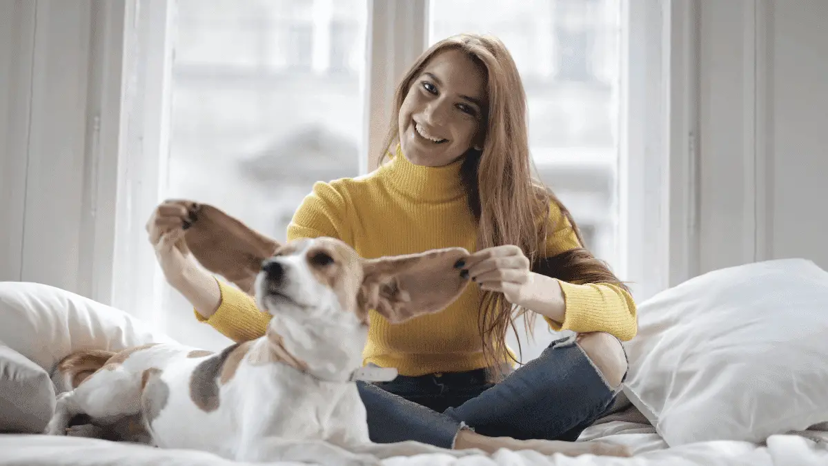 A woman playing with her pet to show how to date yourself
