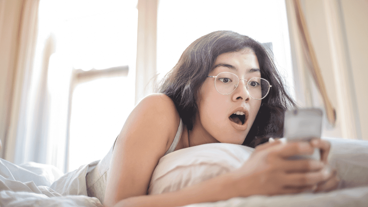 A girl chatting while lying on the bed