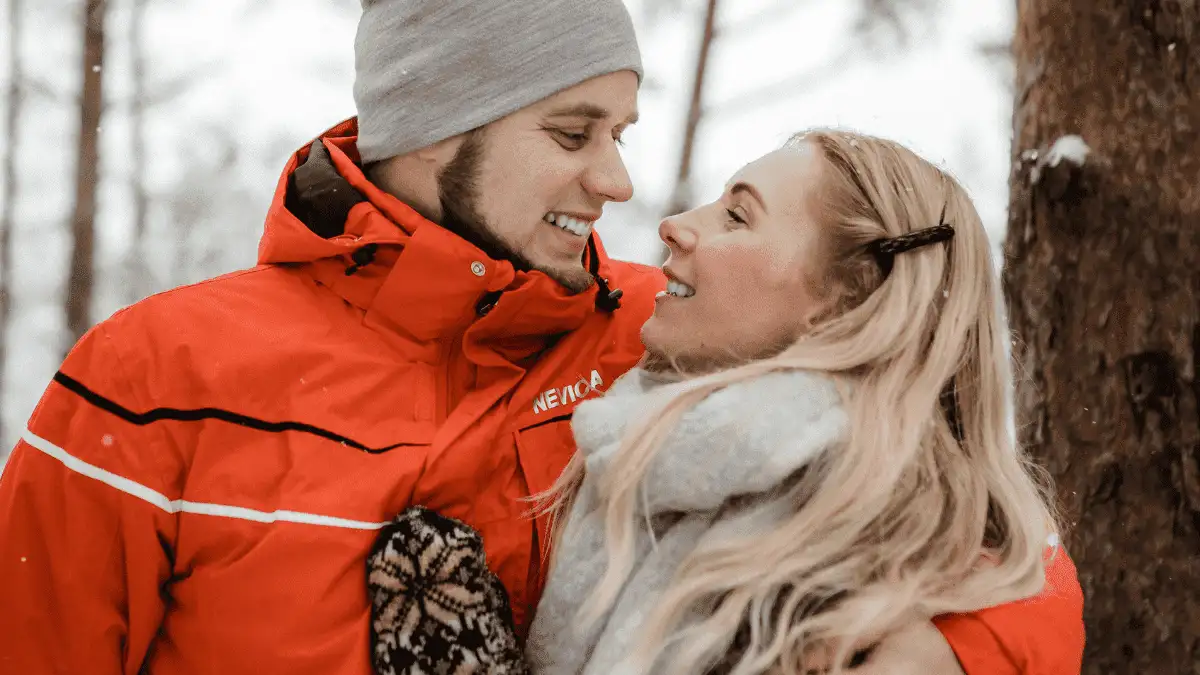 A guy holding a woman gently