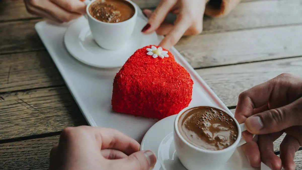 A girl and a guy sipping coffee