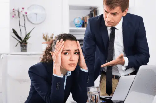 A lady being criticized by her boss at work