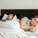 A man and a woman lying on the bed to show Signs he only wants to sleep with you