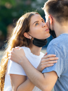 A girl trying to kiss a guy