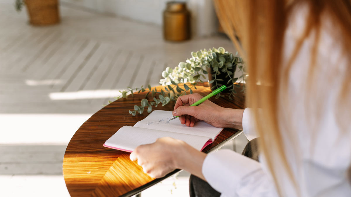 A woman writing down new year habits