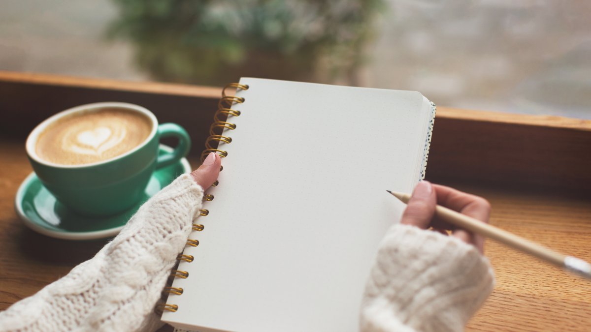 a woman writing down new year habits