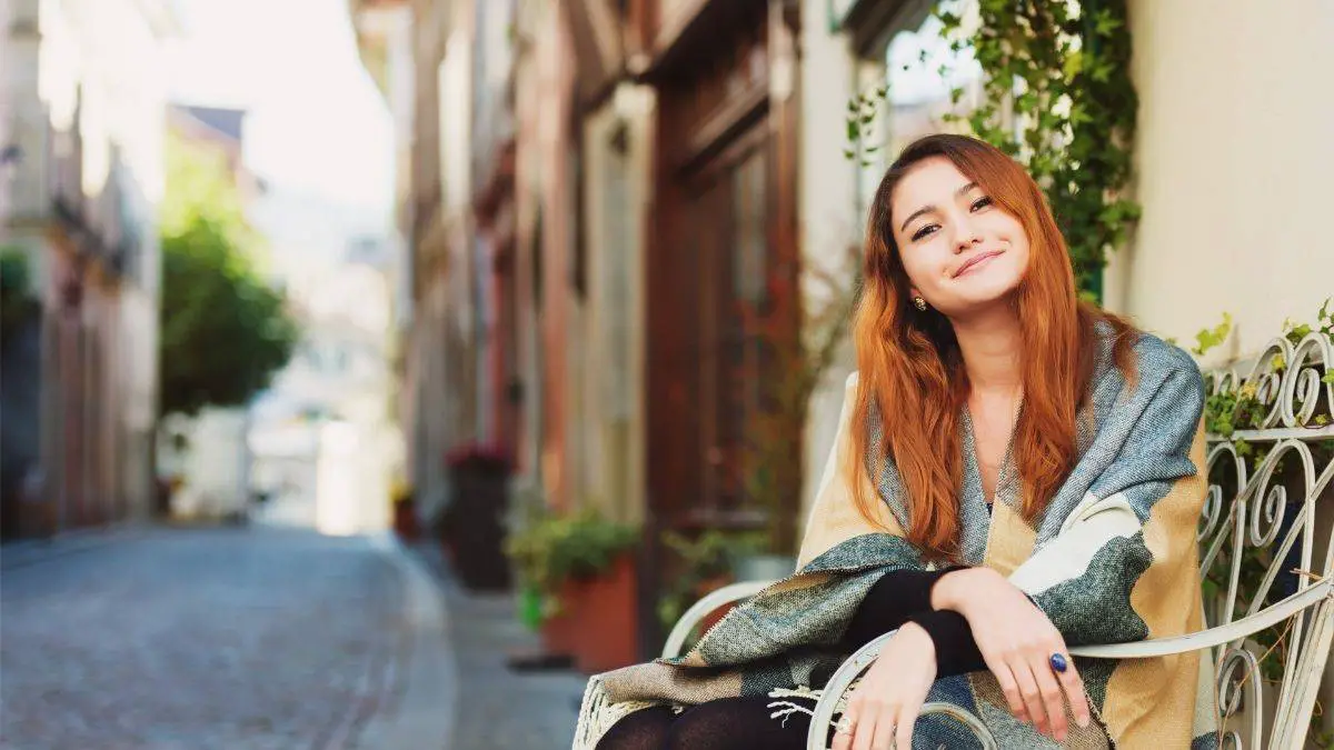 A woman sitting on a chair | 20 Good habits to start in your 20s
